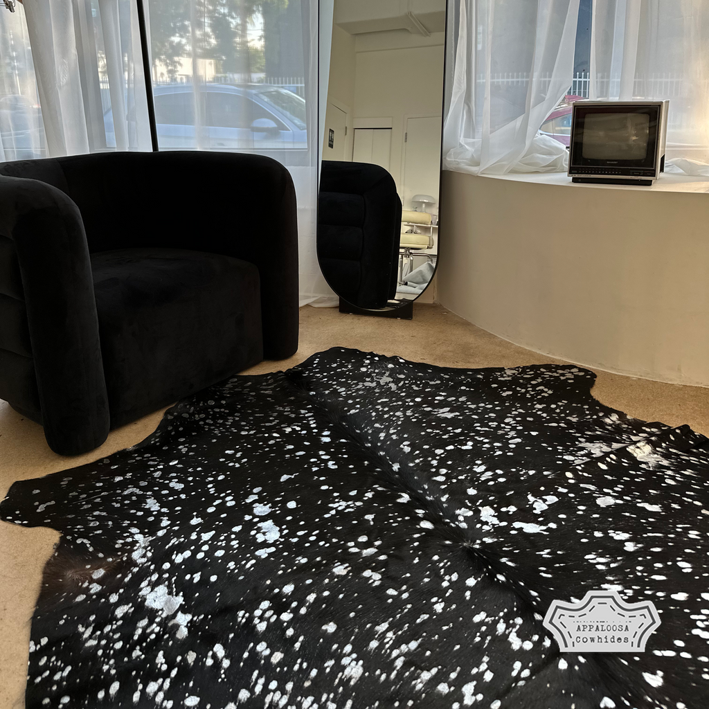 Metallic silver devore on solid black cowhide rug