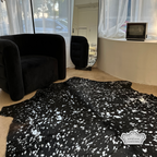 Metallic silver devore on solid black cowhide rug