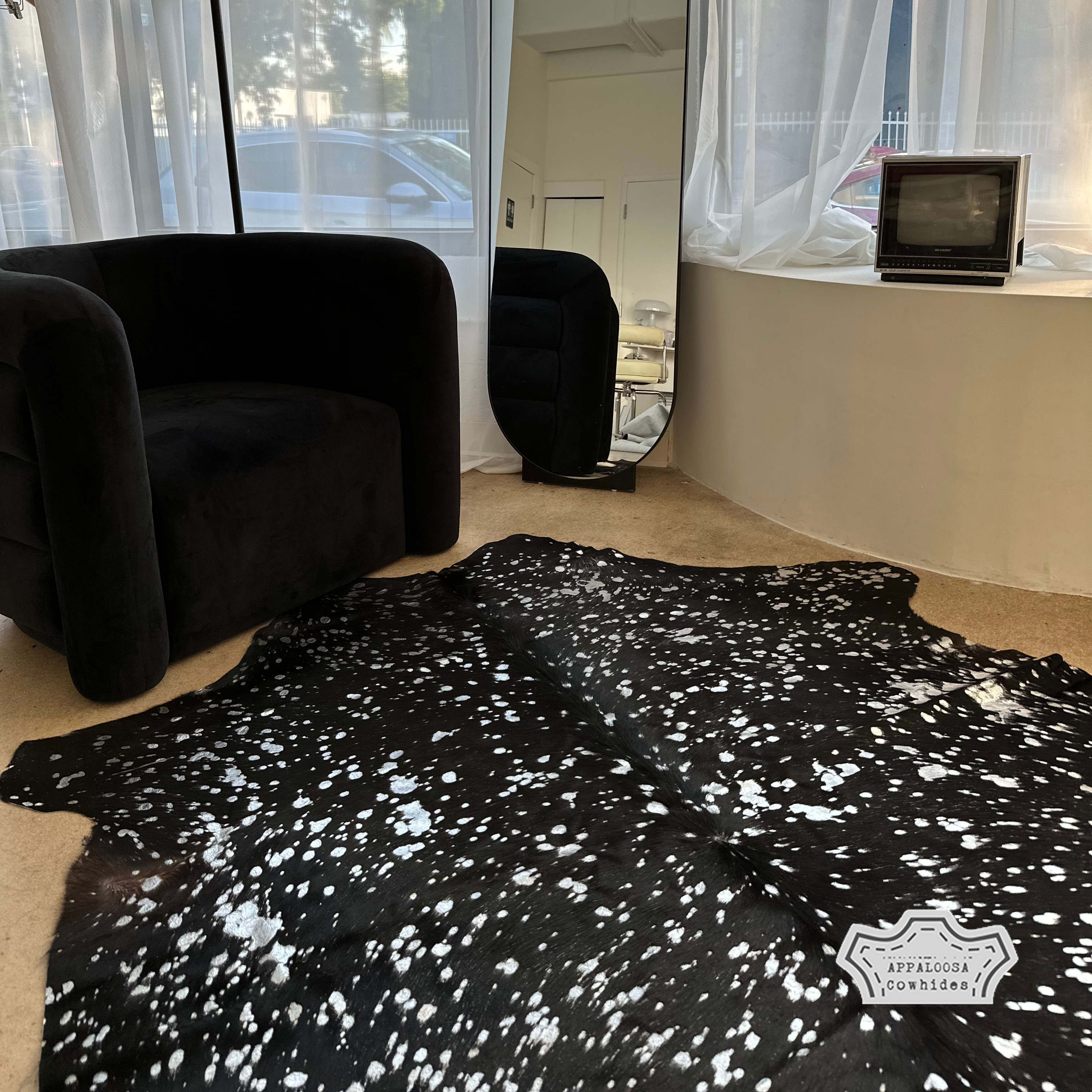 Metallic silver devore on solid black cowhide rug