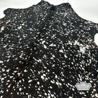 Metallic silver devore on solid black cowhide rug