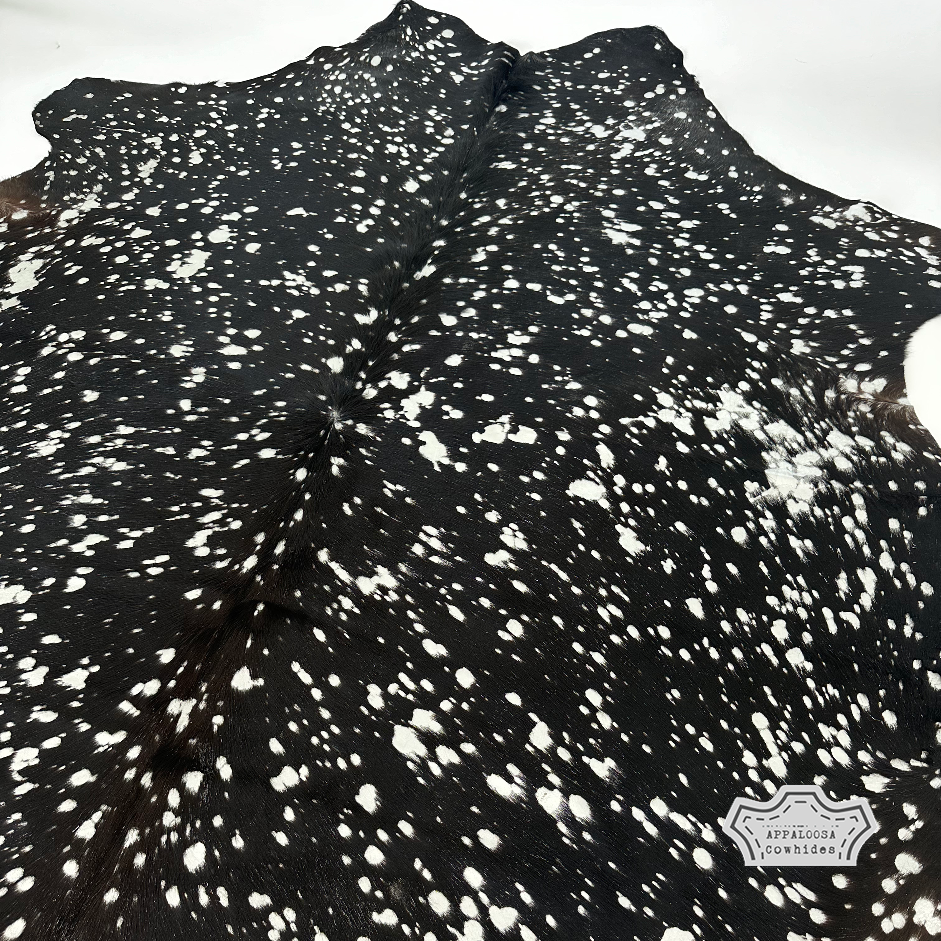Metallic silver devore on solid black cowhide rug
