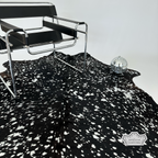 Metallic silver devore on solid black cowhide rug