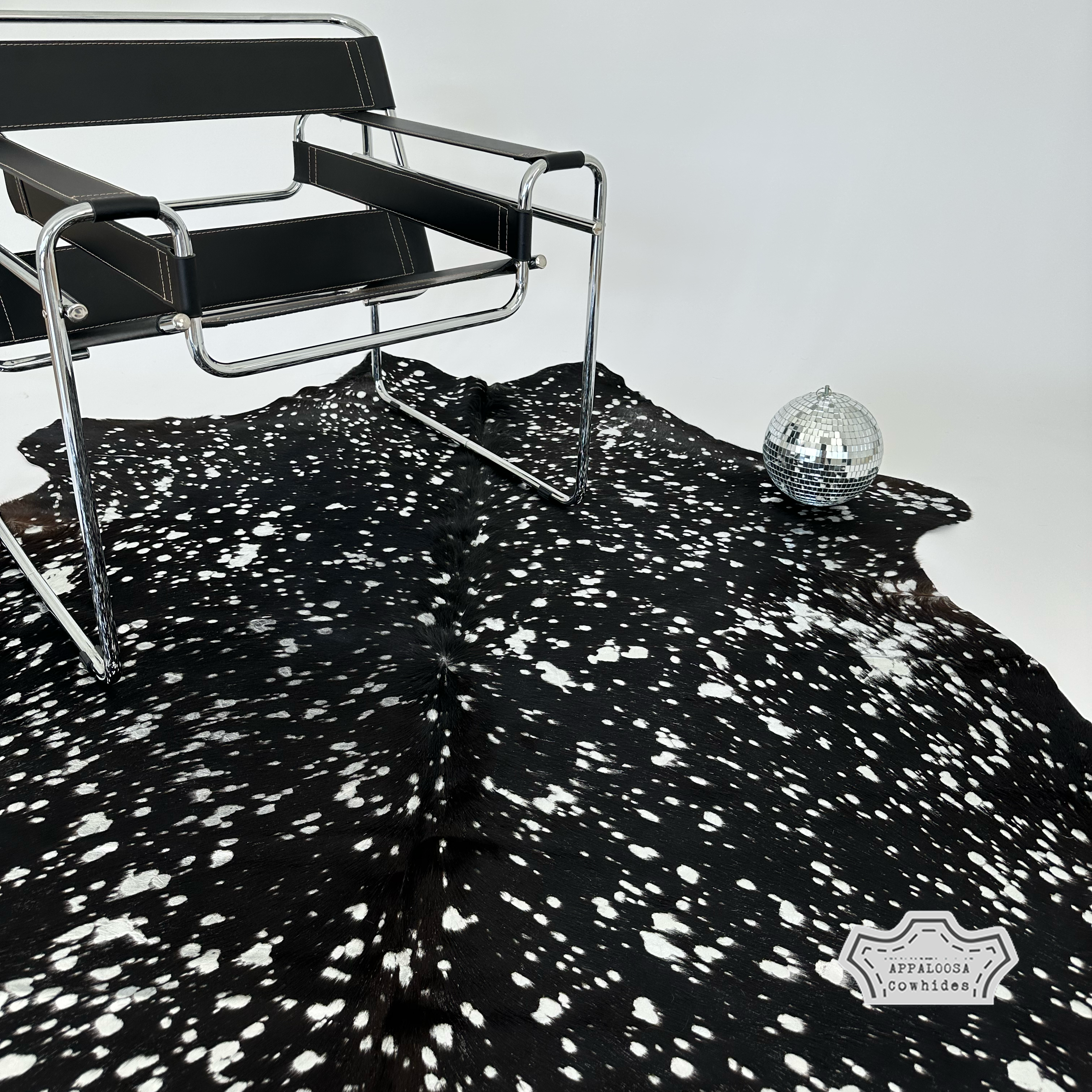 Metallic silver devore on solid black cowhide rug
